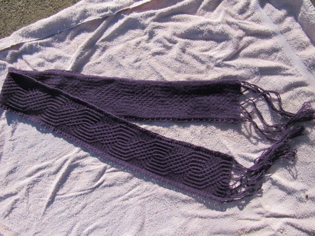 knitted thin purple scarf with thin cables and fringe